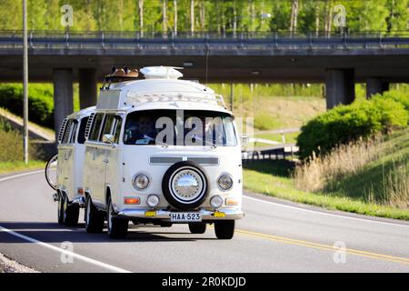White 1972 VW camper van, or Type 2 or kleinbus with matching trailer year 2005 on road on Salon Maisema Cruising 2019. Salo, Finland. May 18, 2019. Stock Photo