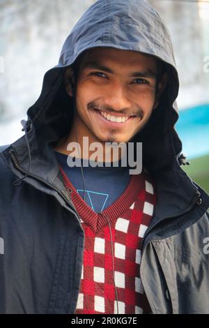 A Young Beautiful Boy Smiling in Portrait. Wearing hoodie, outside in street looking in camera. Stock Photo