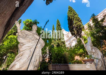 Statues on the cemetery of Campo Santo Teutonico with the dome of St. Peter's Basilica Basilica di San Pietro in the background, Rome, Latium, Italy Stock Photo