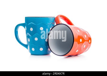 The polka dot mugs isolated on the white background. Stock Photo