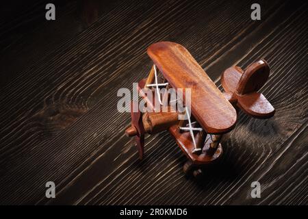 Wood toy plane hand made model on rustic wooden table. Stock Photo