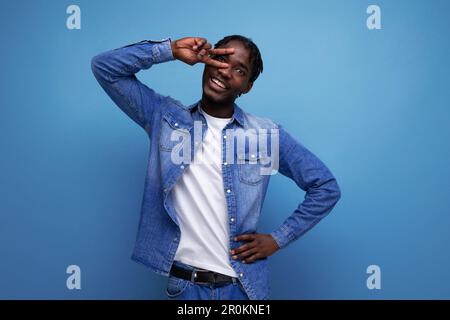 smiling american man with afro curls in casual denim outfit Stock Photo