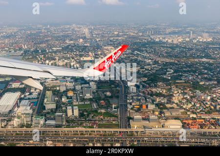 Bangkok Thailand - March 28, 2019: AirAsia (a popular low-cost airline)'s aircraft wing just took off from Don Mueang Airport. The ground image shows Stock Photo