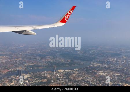 Bangkok Thailand - March 28, 2019: AirAsia (a popular low-cost airline)'s aircraft wing just took off from Don Mueang Airport. The ground image shows Stock Photo