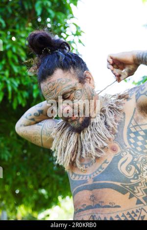 FRENCH POLYNESIA, Tahaa Island. Portrait of tattoo artist Tavita Monea at his home on Tahaa Island. Stock Photo