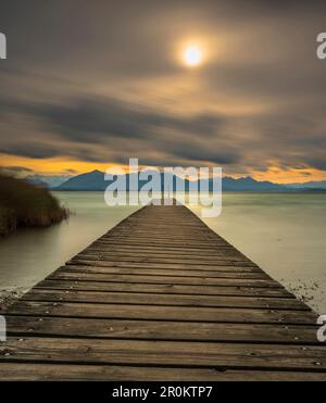 Autumn storm on Lake Chiemsee with view over the jetty to the Chiemgau Alps and Kaisergebirge, Chieming, Upper Bavaria, Germany Stock Photo