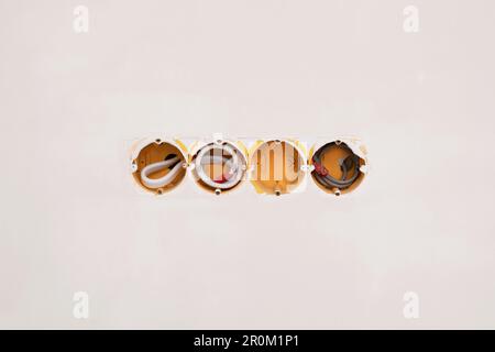 Holes for socket in light grey wall Stock Photo
