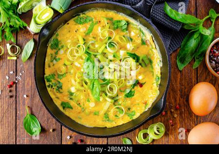 Omelette with Leek and Herbs, Delicious Snack or Breakfast on Wooden Background Stock Photo