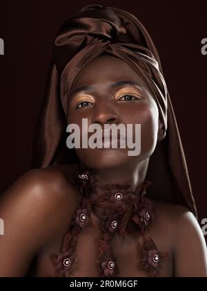 Dont hide your heritage, wear it proudly. Studio portrait of an attractive young woman posing in traditional African attire against a black background Stock Photo
