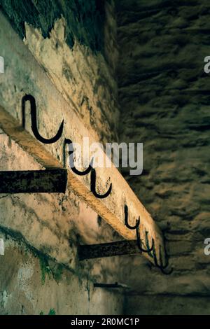 Row of steel hooks in a barn. Stock Photo