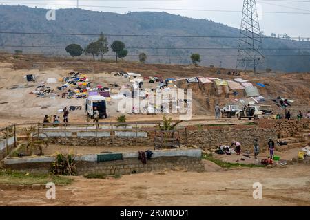 Akamasoa, Madagascar - October 28, 2022: Malagasy people dry their clothes on a rock in Akamasoa village. Traditional way of drying clothes in Africa. Stock Photo