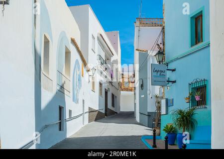 Calpe, Spain - April 14, 2023: View to cozzy empty streets with colorful houses, restaurants, bar terraces in Calpe historic center. Calpe, Alicante Stock Photo