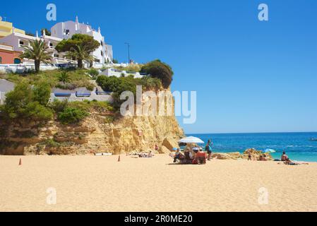 Few people on the beach in bright blue sky in Carvoeiro, Lagoa, Algarve, Portugal Stock Photo