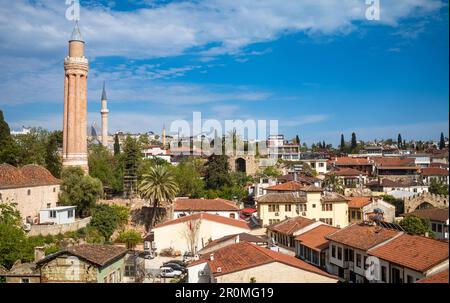 A view across the red-tiled rooftops and ancient mosque minarets in the old town of Kaleici in Antalya, Turkey (Turkiye).   This historic settlement w Stock Photo