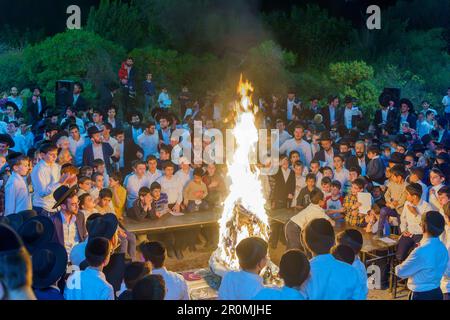 Haifa, Israel - May 08, 2023: Ultra-Orthodox Jews gather around a fire to celebrate the Annual Holiday of Lag-BaOmer, in Haifa, Israel Stock Photo