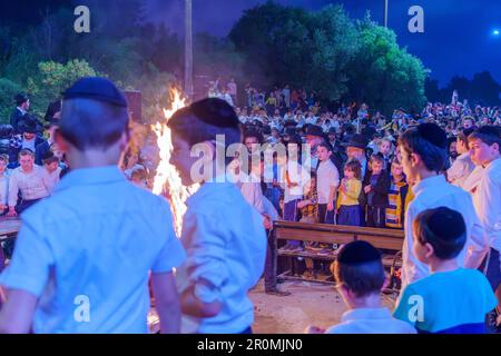 Haifa, Israel - May 08, 2023: Ultra-Orthodox Jews gather around a fire to celebrate the Annual Holiday of Lag-BaOmer, in Haifa, Israel Stock Photo