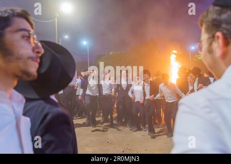 Haifa, Israel - May 08, 2023: Young Ultra-Orthodox Jews dance in circle to celebrate the Annual Holiday of Lag-BaOmer, in Haifa, Israel Stock Photo