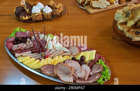 Plate of mixed meats and cheeses. Stock Photo