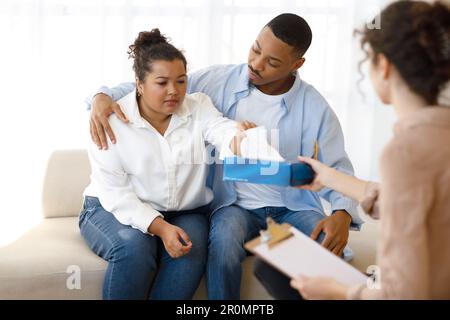 Unhappy black couple attending family therapy session Stock Photo