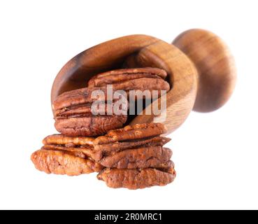 Pecan nuts in wooden scoop, isolated on white background. Shelled pecan. Clipping path. Stock Photo