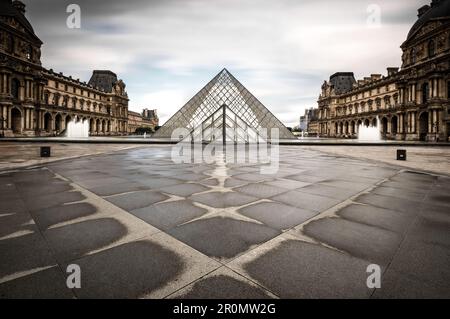 Courtyard of the Louvre with a view of the glass pyramid after the rain, Paris, Île-de-france, France Stock Photo