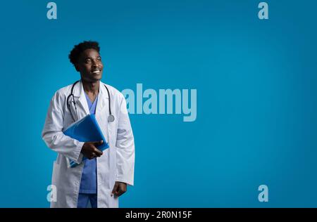 Cheerful young black doctor with medical chart, copy space Stock Photo