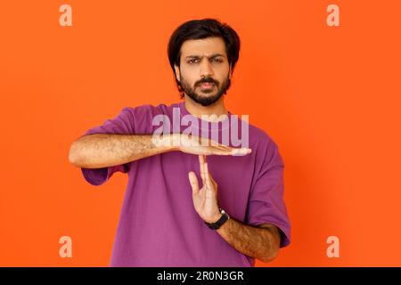 Serious tired indian man showing timeout symbol with hands Stock Photo