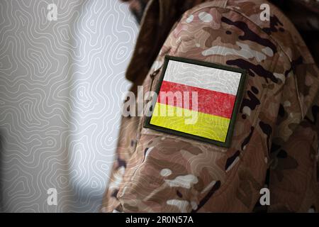 North Ossetia Soldier. Soldier with flag North Ossetia, North Ossetia flag on a military uniform. Camouflage clothing Stock Photo