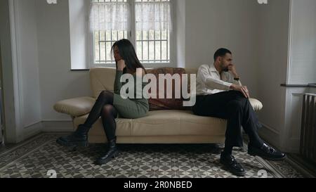 Alienated couple on the brink of separation. Young man and woman giving each other the silent treatment during relationship crisis Stock Photo