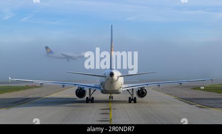 Landing of an Airbus A319 of the German Lufthansa in the fog. Munich Franz Joseph Strauß, Bavaria, Germany Stock Photo