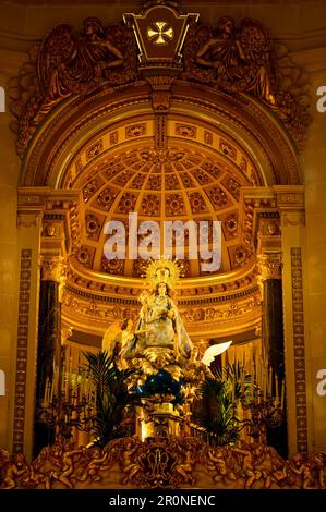 Co-cathedral of Saint Nicolas de Bari. The interior feature shows a religious statue image of the Virgin Mary below a domed altar. Stock Photo