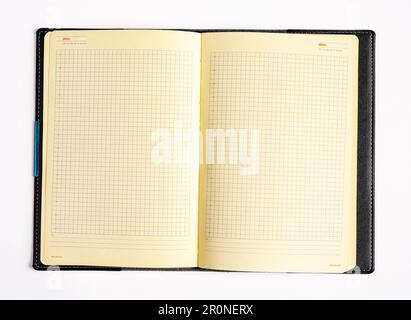 Open planner, notebook, blank checkered grid pages isolated on white. Stock Photo