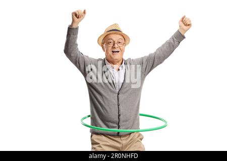 Portrait of an excited elderly man spinning a hula hoop isolated on white background Stock Photo