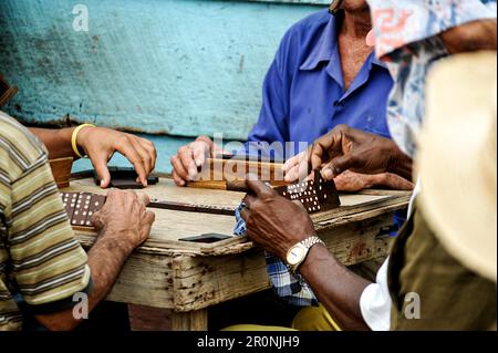 Men play dominoes on the street in the capital of Cuba. Havana. Stock Photo