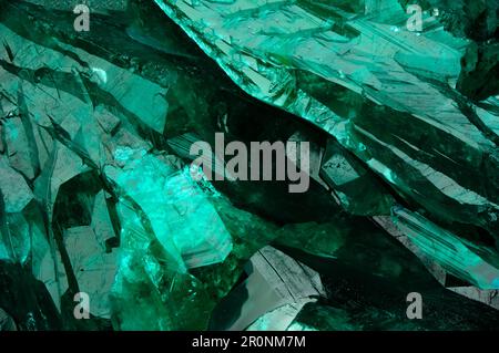 Dioptase crystal macro detail texture background. close-up raw rough unpolished semi-precious gemstone Stock Photo