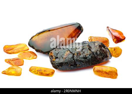 amber macro detail white isolated background. close-up Rough raw unpolished and polished semi-precious gemstone. Stock Photo