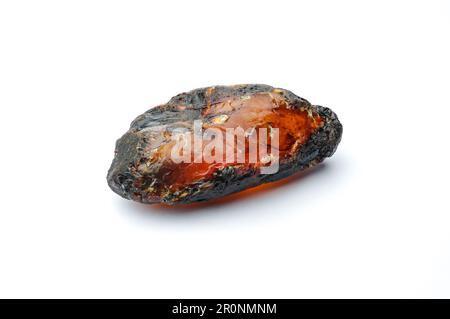 amber macro detail white isolated background. close-up Rough raw unpolished and polished semi-precious gemstone. Stock Photo