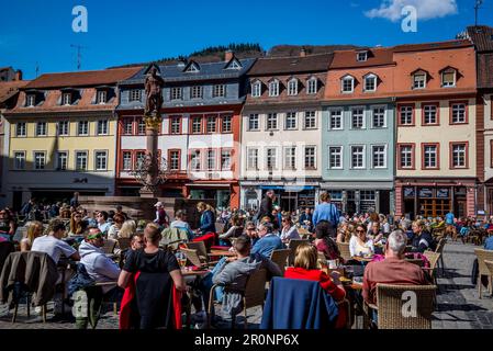 Cafes full of people at the Marktplatz, a central square in the old town, the Altstadt, Heidelberg, Germany Stock Photo