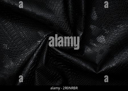 Vegan faux Snakeskin leather texture. minimalist and elegant crumple textile. simple dark black backdrop Stock Photo
