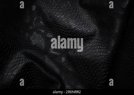 Vegan faux Snakeskin leather texture. minimalist and elegant crumple textile. simple dark black backdrop Stock Photo