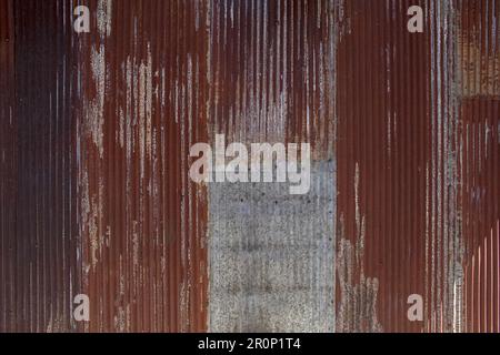 A view of old rusty sheet metal surface with corrugated texture, as a background. Stock Photo