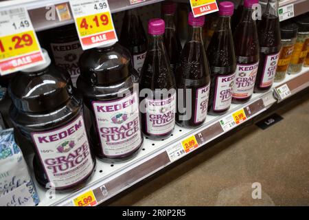 Premium Photo  Glass bottle of juice on a fridge shelf