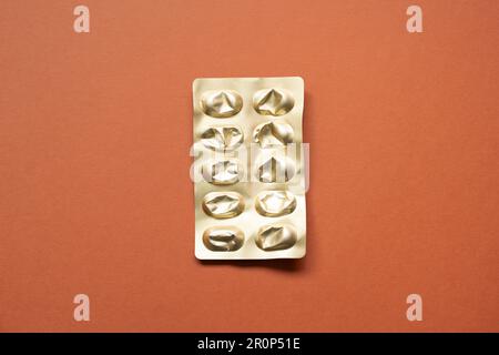 Empty blister pack. Pharmacy drug pill capsule package isolated on red background. top view, copy space Stock Photo