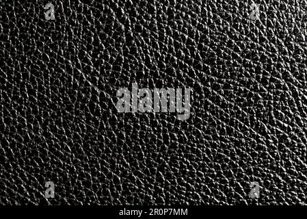 Texture of black genuine leather in black color. Leather. Material Stock Photo
