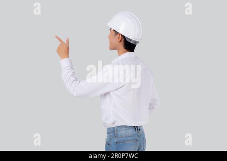 Portrait young asian man is engineer wearing helmet standing and with confident isolated white background, male is architect or contractor presenting Stock Photo