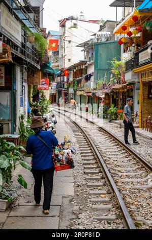 The Train Street with tracks flanked by cafés and restaurants in eclectic styles of buildings. Stock Photo