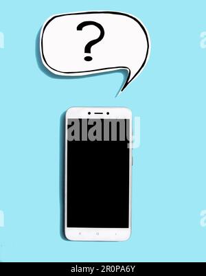 Top view mobile phone with question mark on speech bubbles on blue background. Ask question concept Stock Photo