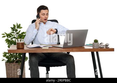 businessman working with laptop and having phone conversation Stock Photo