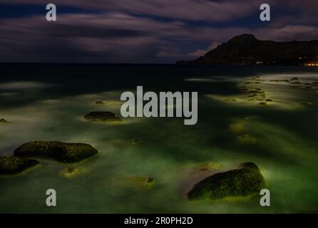 Rocks in moonlit stormy sea off southern coast of Crete Stock Photo