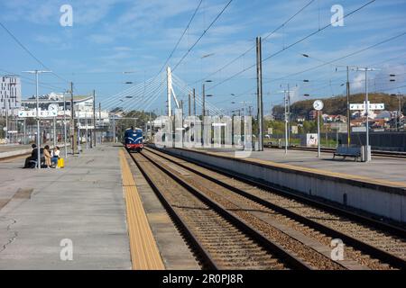 PORTO, PORTUGAL - NOVEMBER 1, 2022 Campanha Train Station with a blue engine just pulling in Stock Photo